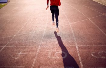 An athlete running on the race track.